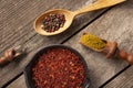 A set of spices and herbs. Indian cuisine. Pepper, salt, paprika, basil, turmeric. On a black wooden background. Top view Royalty Free Stock Photo