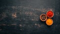 A set of spices and herbs. Indian cuisine. Pepper, salt, paprika, basil, turmeric. On a black wooden chalkboard. Royalty Free Stock Photo