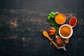 A set of spices and herbs. Indian cuisine. Pepper, salt, paprika, basil, turmeric. On a black wooden chalkboard. Royalty Free Stock Photo