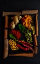A set of spices and herbs. Indian cuisine. Pepper, salt, paprika, Ginger cinnamon, basil, turmeric. On a black background.