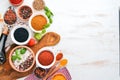 A set of Spices and herbs on a white wooden table. Basil, pepper, saffron, spices. Indian traditional cuisine. Royalty Free Stock Photo