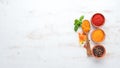 A set of Spices and herbs on a white wooden table. Basil, pepper, saffron, spices. Indian traditional cuisine. Royalty Free Stock Photo