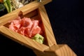 Set with spicy wasabi paste and pickled ginger on a wooden stand, top view. Maki and rolls with tuna, salmon, shrimp, crab and