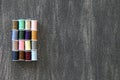 Set of spools of colored threads for sewing and fashion design on vintage wooden gray background Royalty Free Stock Photo