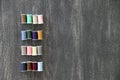 Set of spools of colored threads for sewing and fashion design on vintage wooden gray background Royalty Free Stock Photo