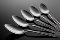 A set of spoons on black background