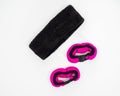 Set of sports accessories for sports activities, pink hand weights and a black headband on a white background Royalty Free Stock Photo