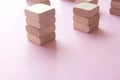 Set of stacks of wooden cubes on pink background Royalty Free Stock Photo