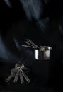 A set of stainless measuring cups and spoon in side view shot in dark moody style Royalty Free Stock Photo