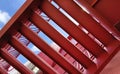 A set of stairs ascending a large red wall Royalty Free Stock Photo