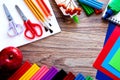 A set of stationery items on a wooden background. Colored paper, plasticine, and paints Royalty Free Stock Photo