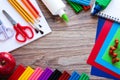 A set of stationery items on a wooden background. Colored paper, plasticine, and paints Royalty Free Stock Photo