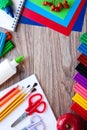 A set of stationery items on a wooden background. Colored paper, plasticine, and paints Royalty Free Stock Photo
