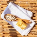 Set for a steam bath. Towel, soap and body brush. View from above. Bright sunshine and shadows