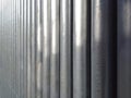 Texture of round chrome steel pipe sort in vertical, abstract background. Architectural detail. Set Steel or Aluminum pipes