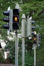 A set of stoplight or traffic lights closeup with an orange light on in a a residential district in Switzerland