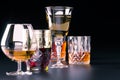 A set of strong alcoholic beverages in glasses, in the presence of whiskey, vodka, rum, brandy, tequila, on a dark background Royalty Free Stock Photo