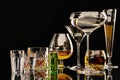 A set of strong alcoholic beverages in glasses, in the presence of whiskey, vodka, rum, brandy, tequila, on a dark background Royalty Free Stock Photo