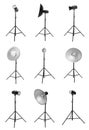 Set with studio flash lights with reflectors on tripods against white background Royalty Free Stock Photo