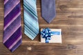 Set of stylish men accessories, mens fashion, necktie and gift box on white wood background. The concept of Fathers Day. Royalty Free Stock Photo