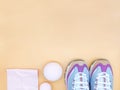 Set of stylish sneakers, fitness rubber band stretch and massage balls on the beige background, fitness concept, copy Royalty Free Stock Photo