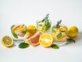 Set summer cold drinks with different citrus and herds in glasses on a white background. Cocktail with grapefruit, orange, lemon Royalty Free Stock Photo