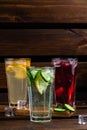 Set of summer refreshing drinks on a wooden background with copy space. three glasses of red, yellow and green lemonade with ice Royalty Free Stock Photo