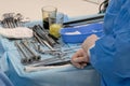 A set of surgical instruments on the medical table. Close-up. Hands of a nurse in white gloves. Operating room surgical hospital Royalty Free Stock Photo