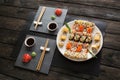 Set of sushi maki and rolls on black rustic wood Royalty Free Stock Photo