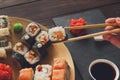 Set of sushi maki and rolls at black rustic wood. Royalty Free Stock Photo