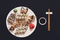 Set of sushi maki and rolls at black rustic wood. Royalty Free Stock Photo