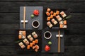Set of sushi maki and rolls on black rustic wood, top view Royalty Free Stock Photo