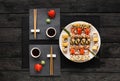 Set of sushi maki and rolls on black rustic wood, top view Royalty Free Stock Photo