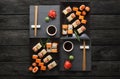 Set of sushi maki and rolls on black rustic wood, top view Royalty Free Stock Photo