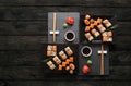 Set of sushi maki and rolls on black rustic wood, top view Royalty Free Stock Photo