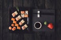 Set of sushi maki and rolls on black rustic wood, top view Royalty Free Stock Photo