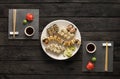 Set of sushi maki and rolls on black rustic wood, top view Royalty Free Stock Photo