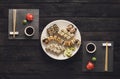 Set of sushi maki and rolls on black rustic wood, top view Royalty Free Stock Photo