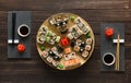 Set of sushi maki and rolls on black rustic wood, top view Royalty Free Stock Photo