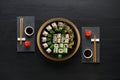 Set of sushi maki and rolls on black rustic wood, top view Royalty Free Stock Photo