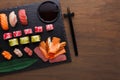 Set of sushi maki and rolls on black rustic wood, top view Royalty Free Stock Photo