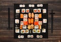 Set of sushi, maki and rolls on brown wood background Royalty Free Stock Photo