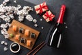 Set of sushi, maki rolls, gift boxes and bottle of champagne with branch of white flowers on stone table Royalty Free Stock Photo