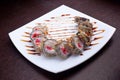 Set of sushi maki shrimp tempura on white plate. Japanese food on background Royalty Free Stock Photo