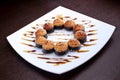 Set of sushi maki shrimp tempura on white plate. Japanese food on background Royalty Free Stock Photo