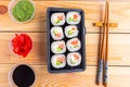 Set of sushi roll in the box on wooden table, top view. Royalty Free Stock Photo