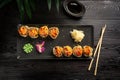 set of sushi rolls on a black plate on a black wooden background Royalty Free Stock Photo