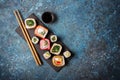 Set of sushi rolls served on a black slate board with chopsticks Royalty Free Stock Photo