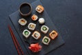 Set of sushi rolls served on stone slate