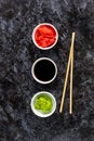 Set for sushi soy sauce ginger wasabi with chopstick on stone background Royalty Free Stock Photo